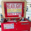 Chips & Cracks Windshield Repair's roller tool box with headlight restoration sign.
